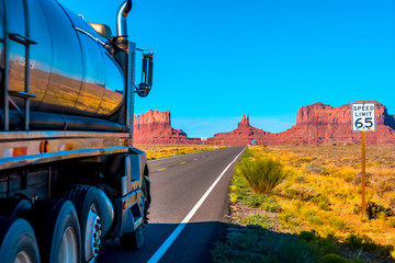 A truck by the road with its yellow lines of Monument Valley, Utah