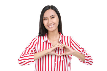 Beautiful young woman showing heart by hands on white background