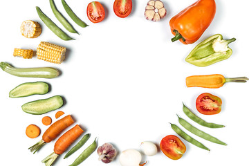 Creative layout made of haricot, tomatoes, pepper, carrot, garlic, maize, zucchini and onion. Organic food background. Flat lay, top view, copy space. Healthy eating concept.
