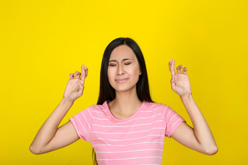 Beautiful young woman on yellow background