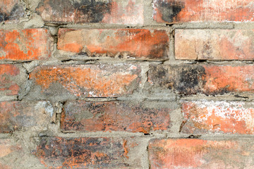 Background of an old dirty brick wall with traces of black soot, texture, close-up