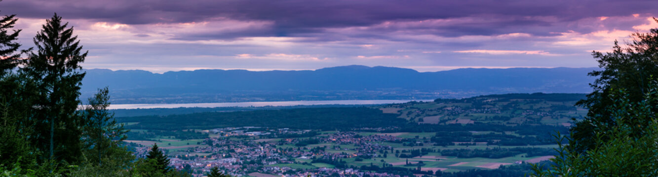 Evening panorama view from the top of the French town Bons-en-Chablais, lake Geneva(lake Leman) and the mountains in Switzerland.Department of Haute-Savoie,region of Auvergne-Rhone-Alpes in France.