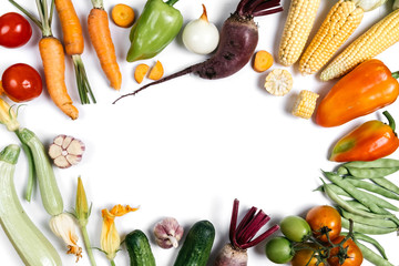 Pattern made of autumn vegetables. Food concept. Tomatoes, onion, cucumber, zucchini, carrot, garlic, red beet, pepper, maize and green haricot on white background. Flat lay, top view, copy space