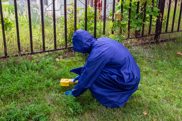 increasing the background radiation in the air and the ground, a researcher with a dosimeter...