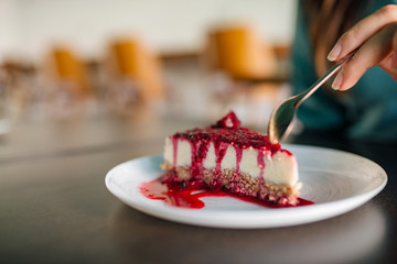 Eating a slice of cake, close-up, copy space.