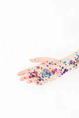 Woman hand with festive color star confetti