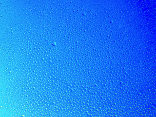Water droplets on the glass with a colored background. Drops of water.