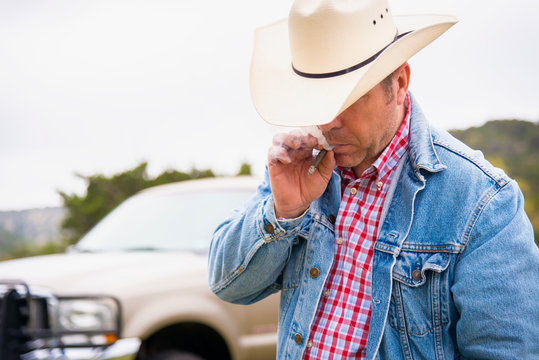 Texas, Cowboy smoking cigar, pick up truck in background
