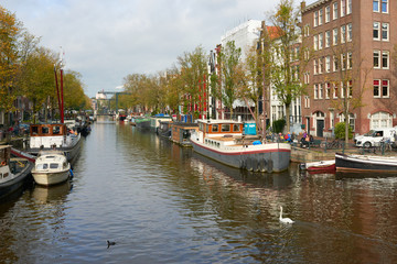 Fototapeta na wymiar Amsterdam. View of the canal in the autumn day.