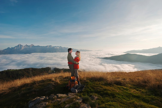 Austria, Steiermark, Reiteralm, Couple of hikers embracing, laughing, side view