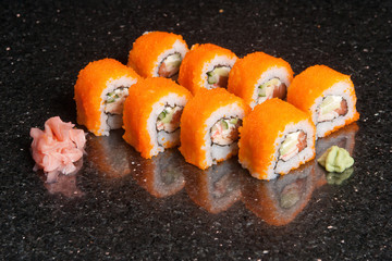 Sushi rolls on black marble background. Fresh Hosomak, Maki, Nigiri, Tempura, Uramaki, Philadelphia pieces with rice, nori and fish. Japanese cusine, Asian food.