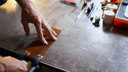 Profession leatherwork concept with copy space. Tanner workhop.