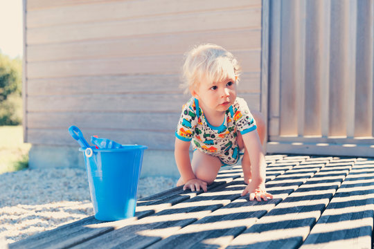Little boy crouching on terrace