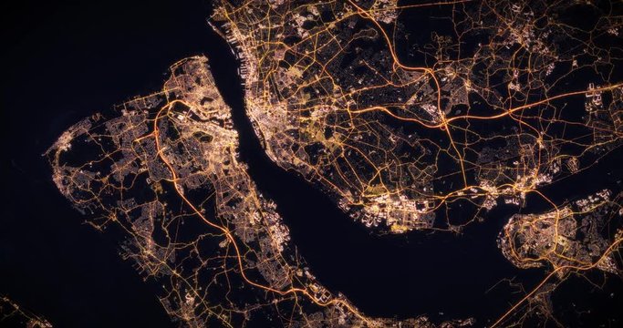 Aerial night view of city of Liverpool, UK. Traffic and street light glowing. Camera flying high above, moving closer and rotating from space filming cinematic straight down. 3d animation rendering.