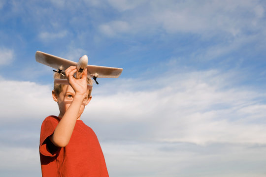 Boy holding model aircraft