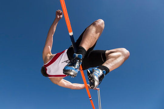 Germany, Mature man curling over high jump