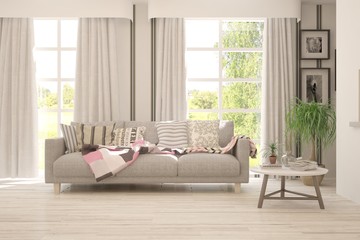 Fototapeta premium Stylish room in white color with sofa and summer landscape in window. Scandinavian interior design. 3D illustration