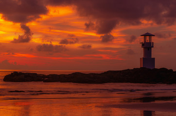 Iconic lighthouse with sunset twilight atmosphere and beautiful colorful sky after sunset.