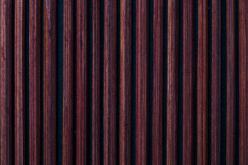 Dark reddish bamboo texture (collection of vegetal and natural fibers). Foreground.