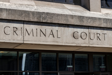 Obraz premium Criminal Court letters in a cement facade I