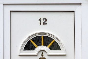 House number 12 on a white front door