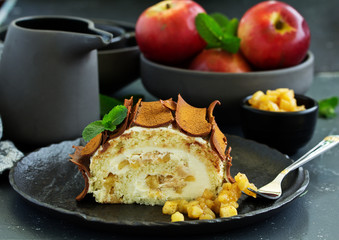 Roulade with apples and caramel, cream. New Year's dessert. Selective focus