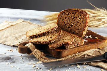 freshly baked bread on wooden board. cutted organic bread