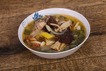 Thai style soup with meat and mushrooms