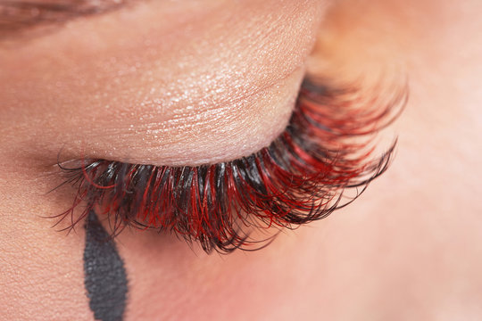 Beautiful macro photography of a woman's eye with make-up of long eyelashes.
