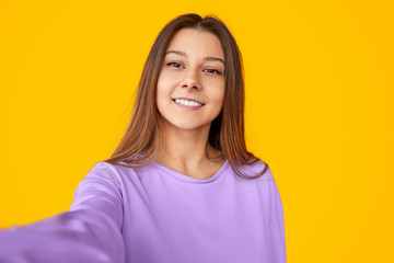 Fototapeta premium Smiling stylish woman taking selfie