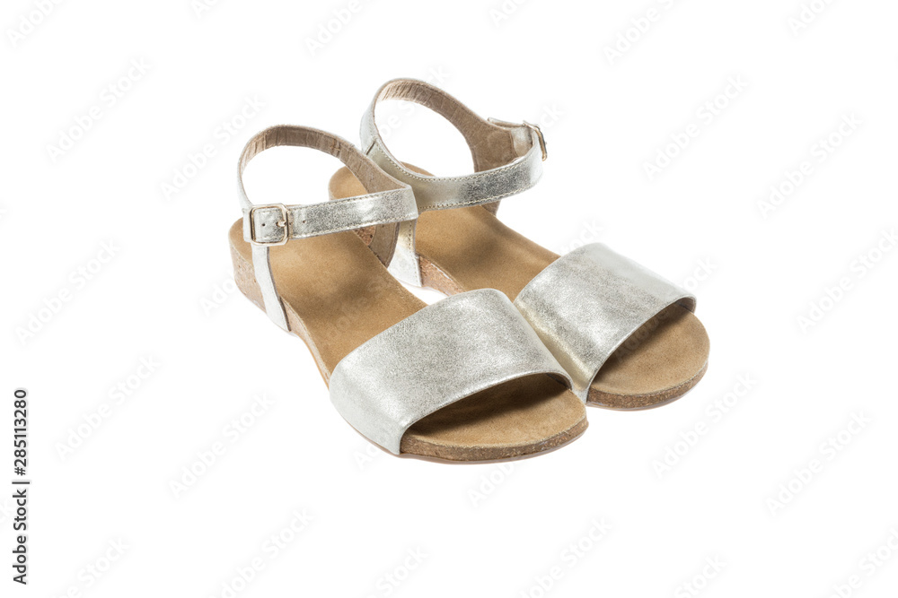 Poster Golden color and brown leather ladies sandals on white background