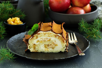 Roulade with apples and caramel, cream. New Year's dessert. Selective focus