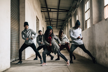 Hip hop team dancing in an old factory.