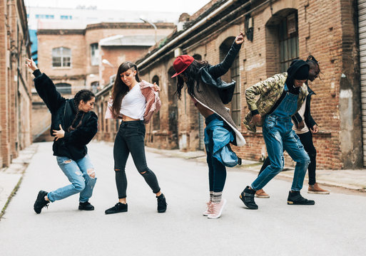 Group of friends dancing hip hop on the street.