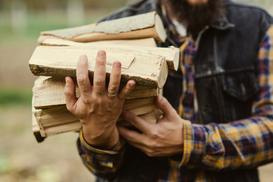 man carries wood pieces