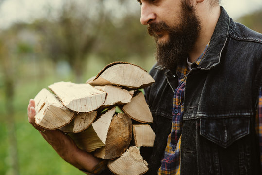 man carries wood pieces