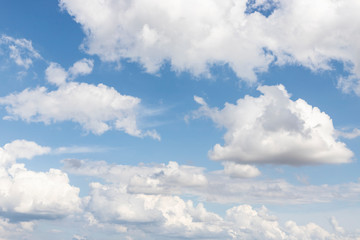 Blue sky with white clouds. The sun is shining behind the clouds. Overcast weather. Summer autumn Winter Spring. Textured background with free, empty space. Traveling, camping.
