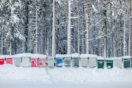 Bright row of frozen mailboxes in countryside