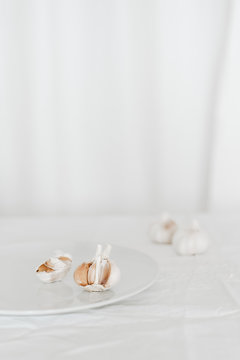 Fresh garlic on white plate