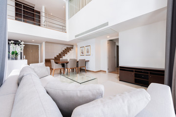 Beautiful and large living room interior with hardwood floors and vaulted ceiling in new luxury home.