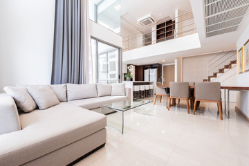 Beautiful and large living room interior with hardwood floors and vaulted ceiling in new luxury home.