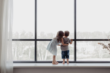 Children on sill looking out window