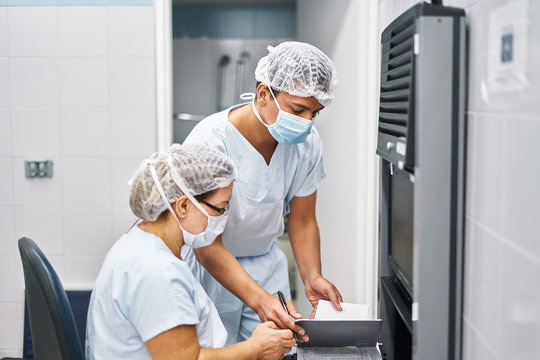 Medical staff writing journal in the operating room