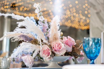luxury dinner Banquet in the restaurant. Beautiful and exquisite decoration of the wedding celebration. Banquet served table with a beige pink tablecloth, plates and candlesticks with candles.