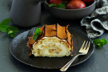 Roulade with apples and caramel, cream. New Year's dessert. Selective focus