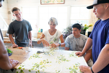 Young men taking a floral arrangement workshop