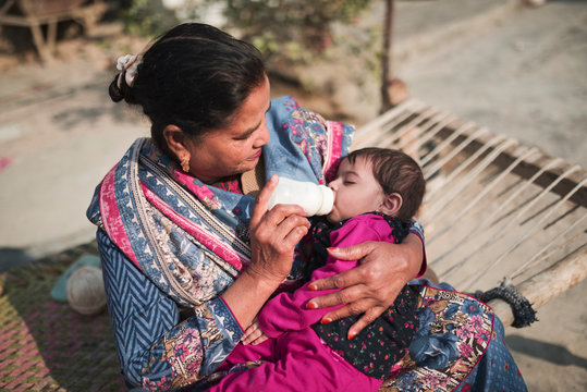 Woman feeding baby with bottle