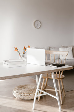 Laptop lying on table near books