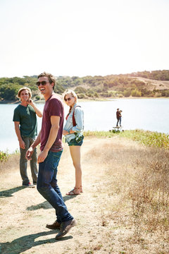 Group of Millennial friends hanging out in nature