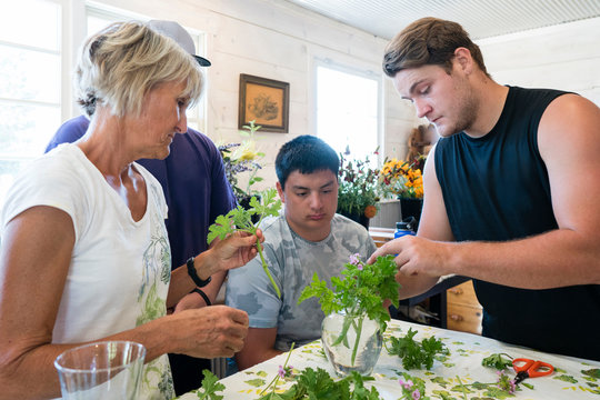 Young men taking a floral arrangement workshop